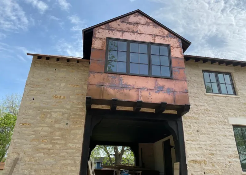 Copper metal panel facade on a stone building for Metal Roof Coating in Rowlett